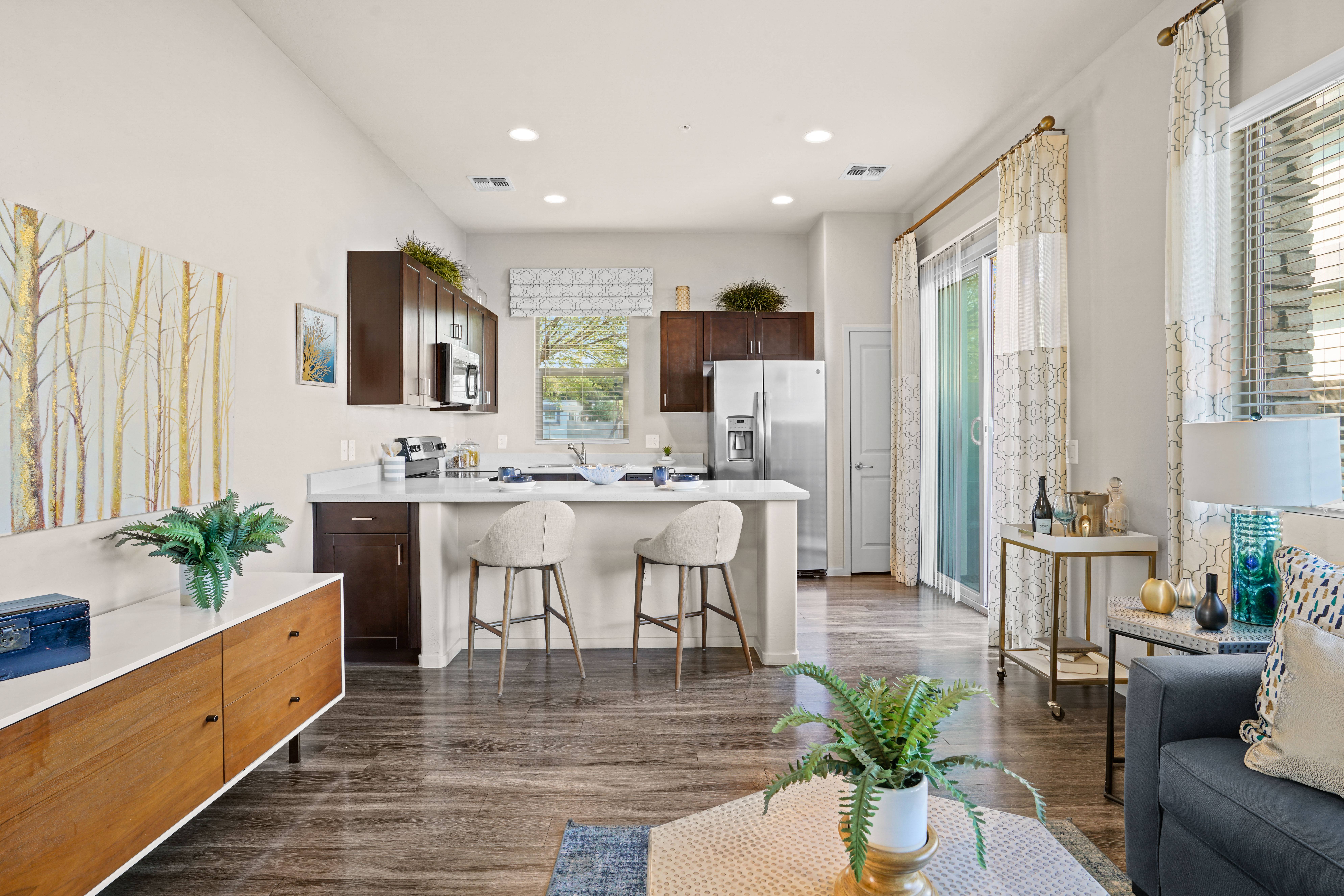 a kitchen and living room with a white counter top and a kitchen island at Olive Queen Creek Apartments, Queen Creek, 85142